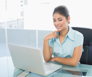 Business Woman at Laptop, Payroll Solutions in Lake City, FL and Gainesville, FL